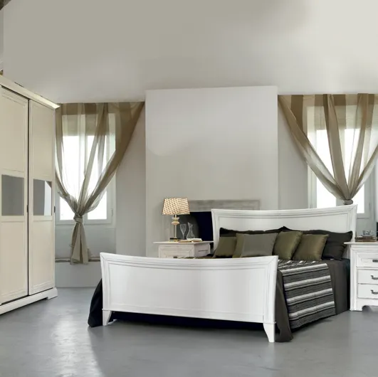 Tranquil white lacquered wooden bed with headboard by Tonin Casa.