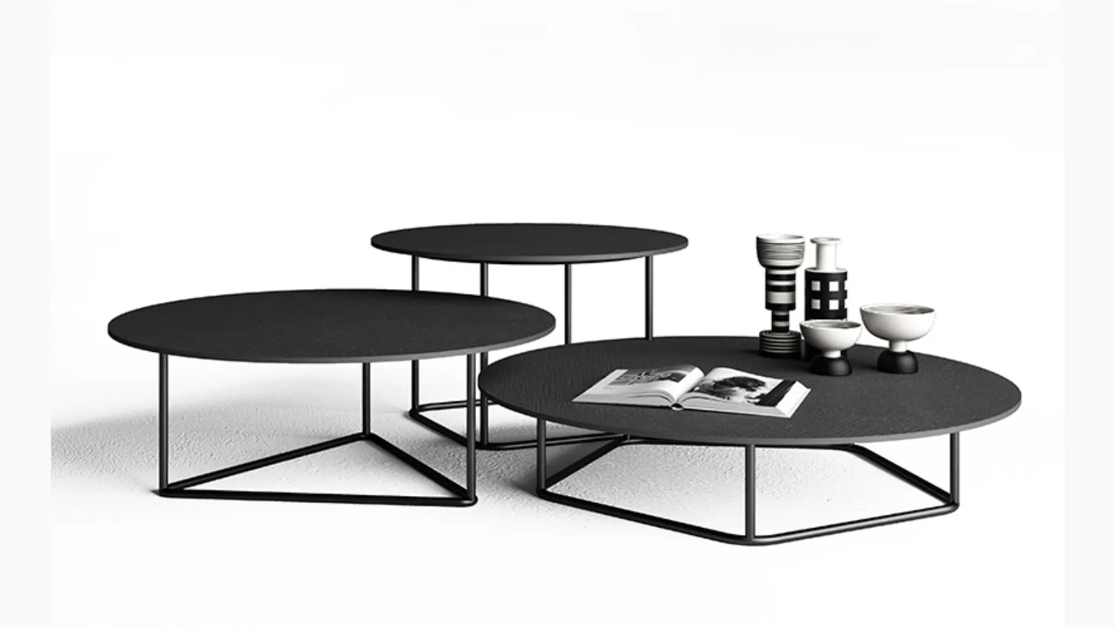 Side tables with anthracite Circus concrete tops by Minotti Italia.