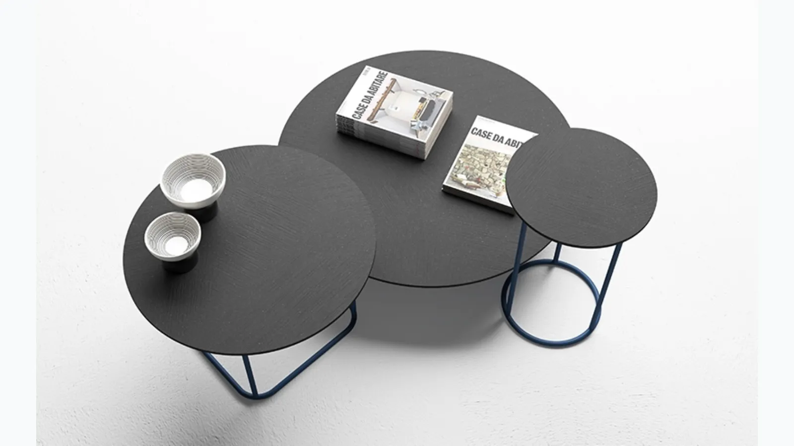 Tables with anthracite Circus cement tops by Minotti Italia.
