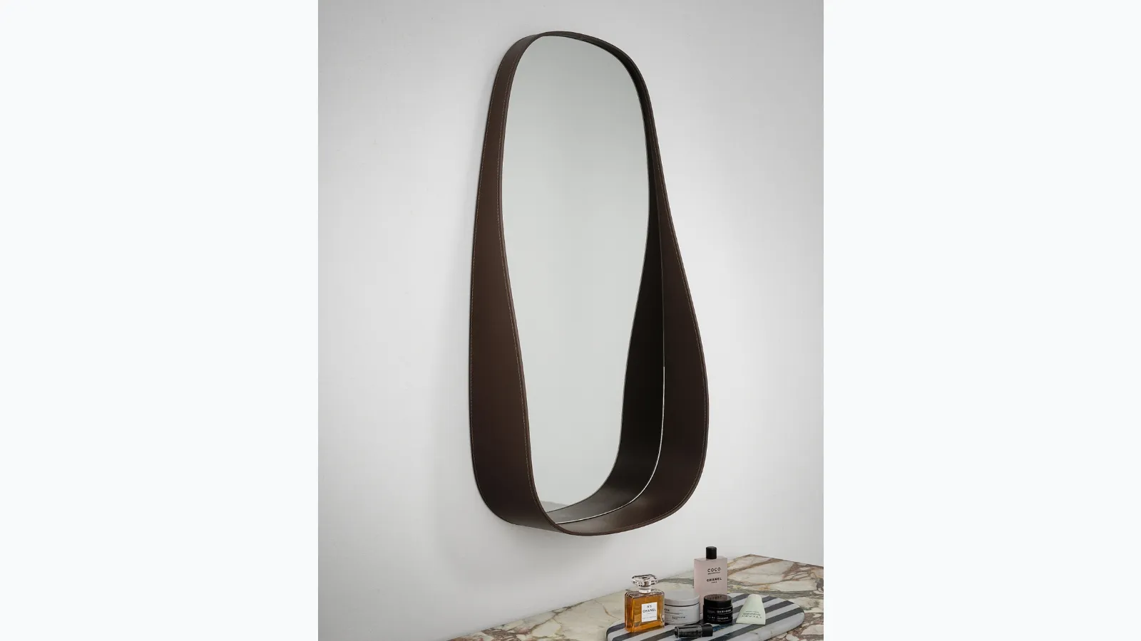 Flow mirror with a leather frame by Novamobili