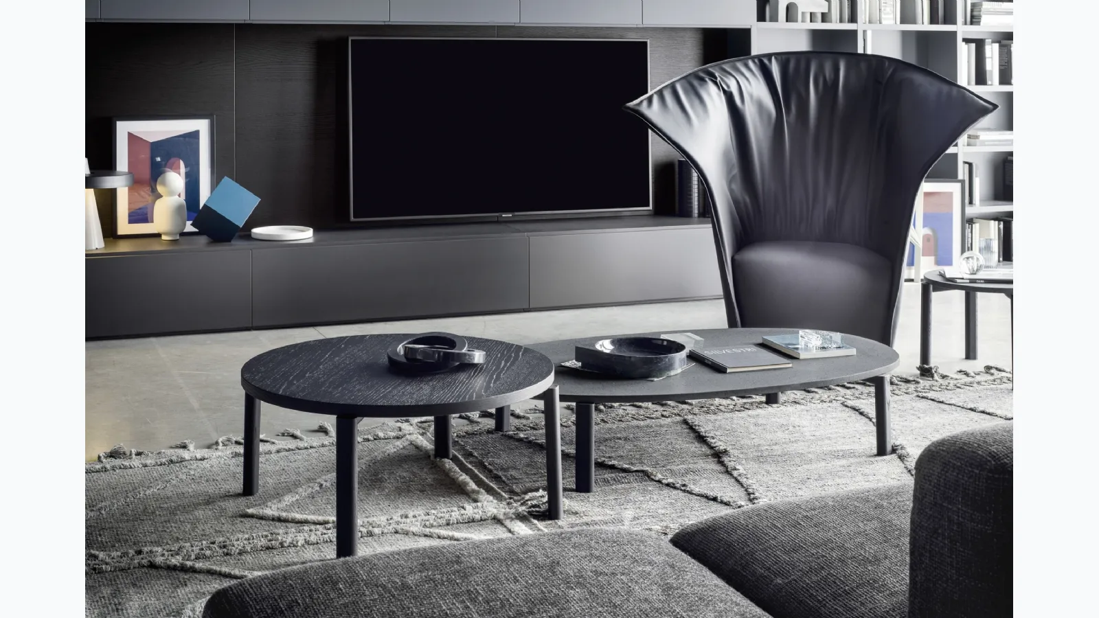 Round wooden coffee table and oval lava stone coffee table Fly by Novamobili.