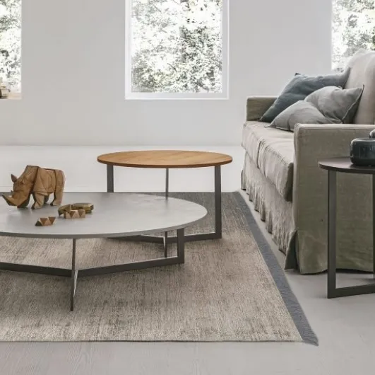 Round coffee table with textured Joy top by Tomasella.