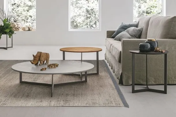 Round coffee table with textured Joy top by Tomasella.