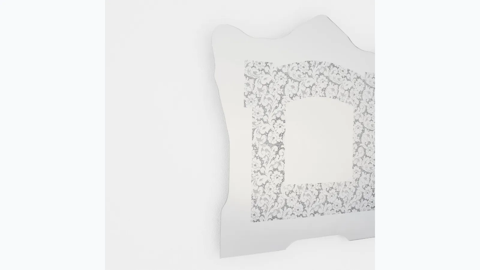 Spizzo mirror with lace insert reflecting Glas Italia mirror.