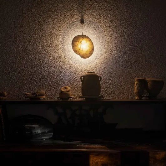 Wall lamp with a marble element centered in a transparent polymethyl methacrylate disc by Gem Foscarini