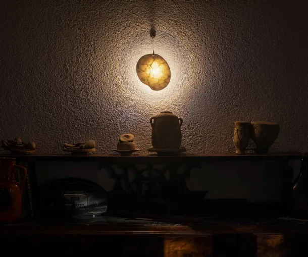 Wall lamp with a marble element centered in a transparent polymethyl methacrylate disc by Gem Foscarini