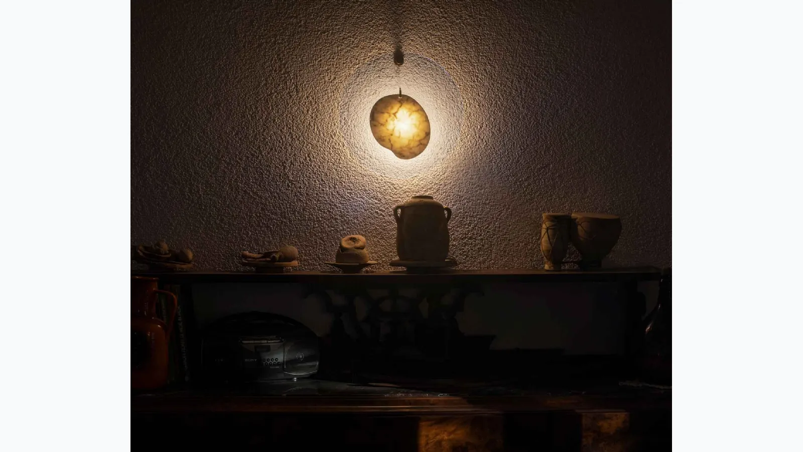 Wall lamp with a marble element centered in a transparent polymethyl methacrylate disc by Gem Foscarini