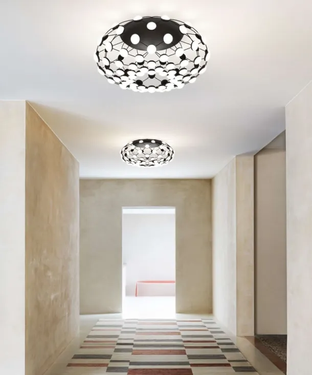 Mesh ceiling lamp with a steel structure and polycarbonate lenses by Luceplan.