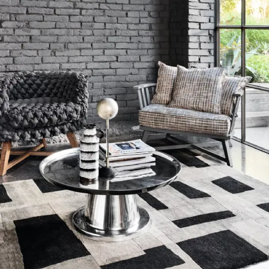 Gray upholstered armchair by Gervasoni