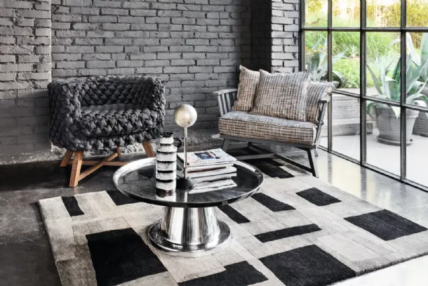 Gray upholstered armchair by Gervasoni