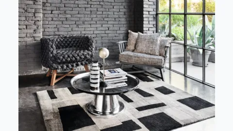 Gray upholstered armchair by Gervasoni