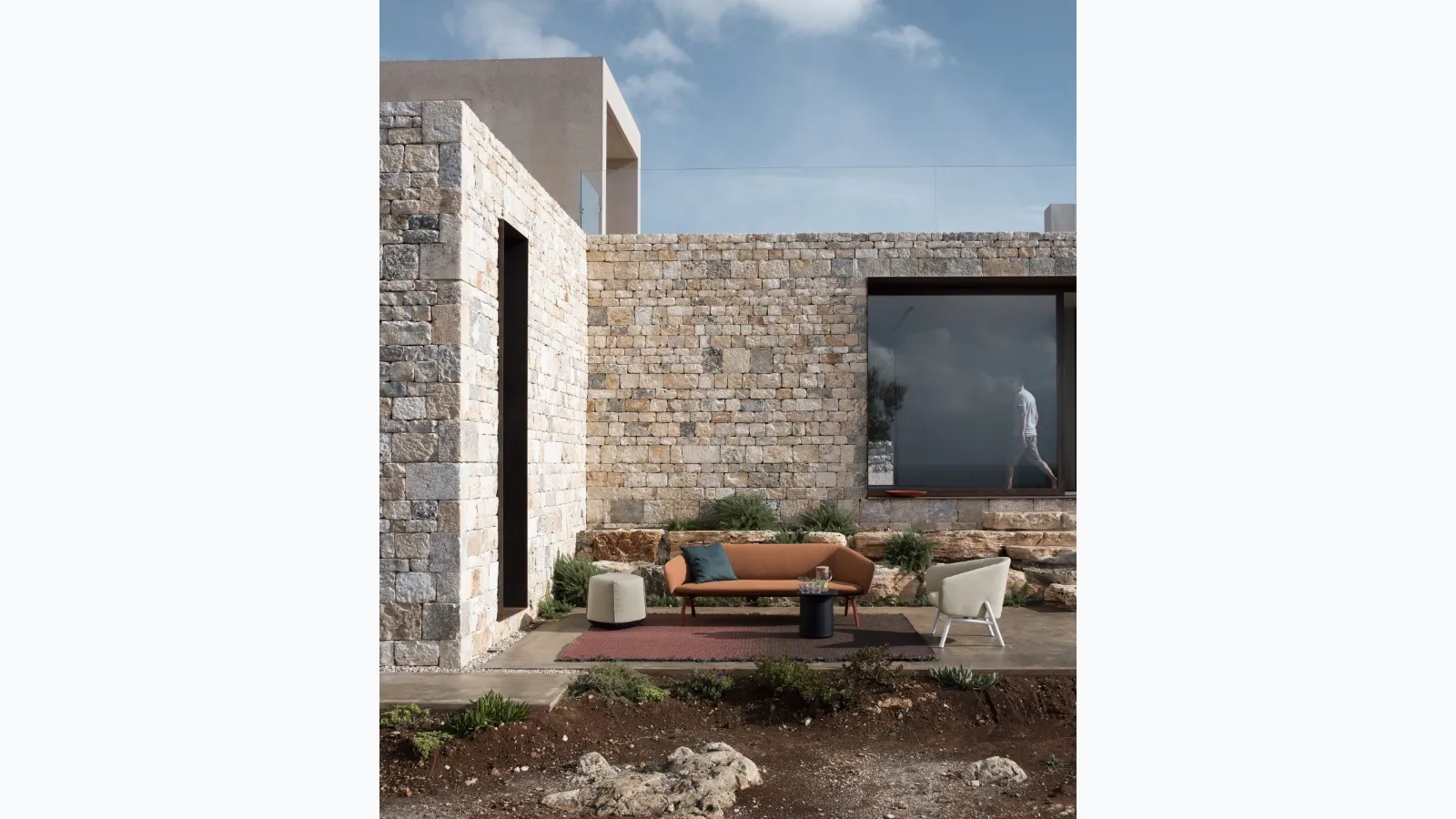 Fabric armchair with a curved and welcoming seat, with a light metal structure painted in Tuile by Kristalia.