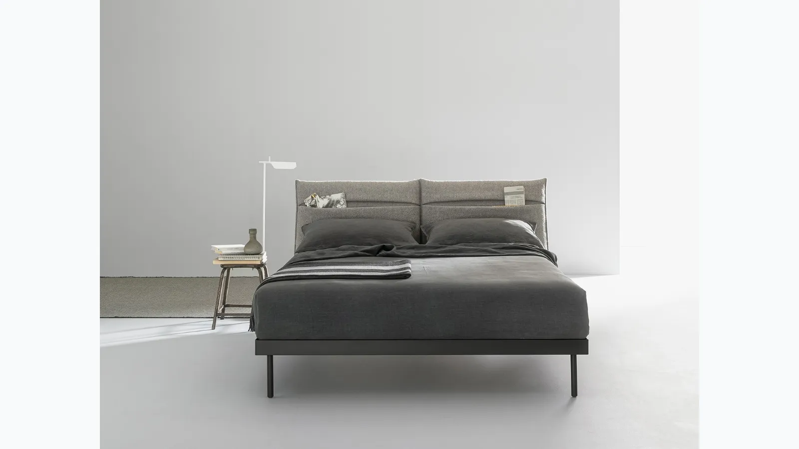 Double bed with fabric padded headboard with Ajar pocket by Caccaro.