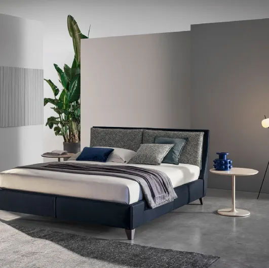 Bed with headboard in Twils' Attico leather and fabric.