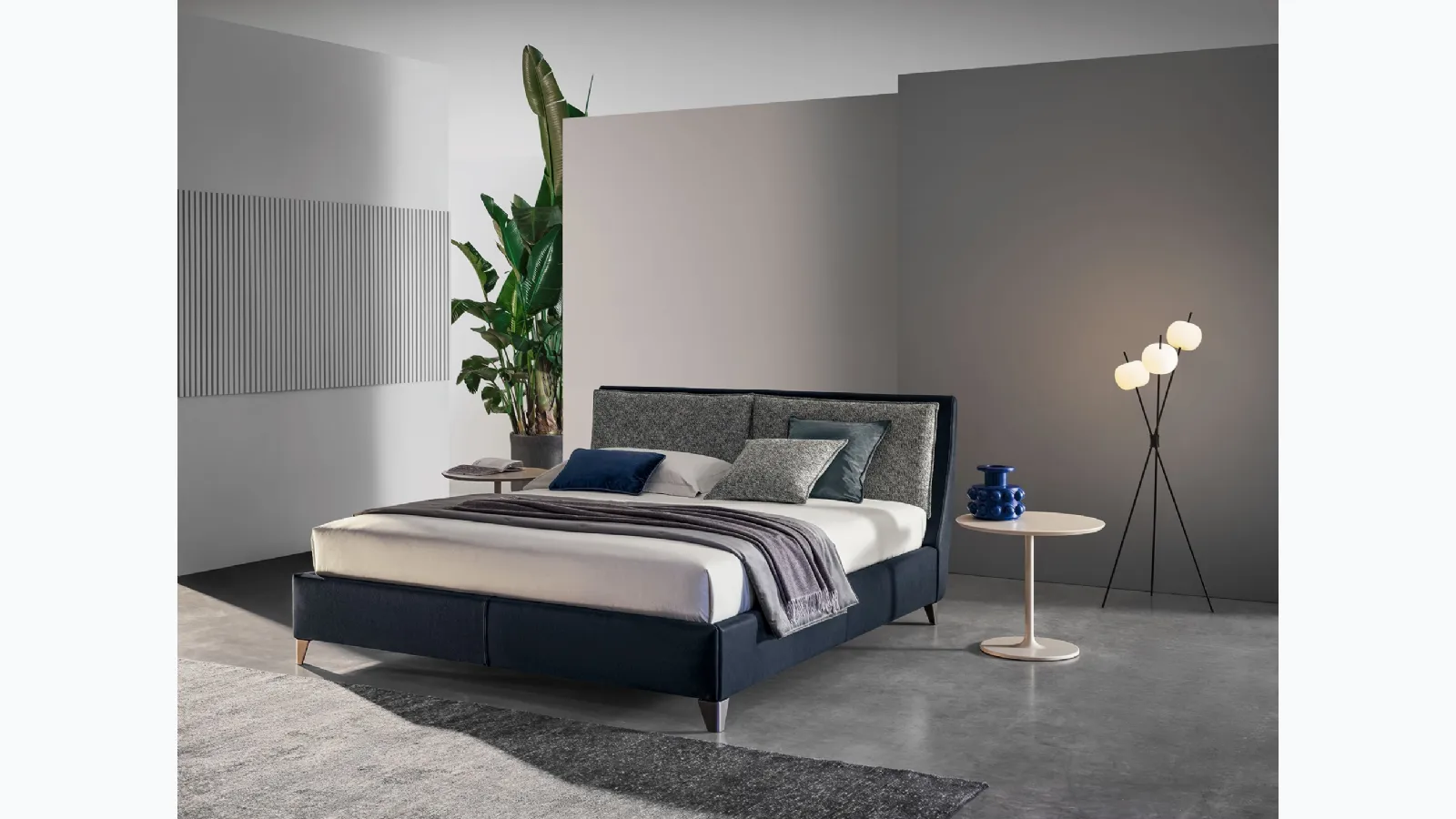 Bed with headboard in Twils' Attico leather and fabric.