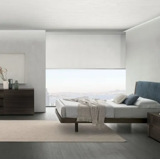 Bliss double bed in material oak with a headboard softened by a padded panel by Tomasella.