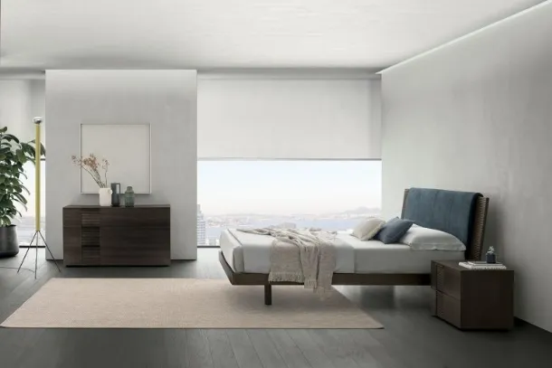 Bliss double bed in material oak with a headboard softened by a padded panel by Tomasella.