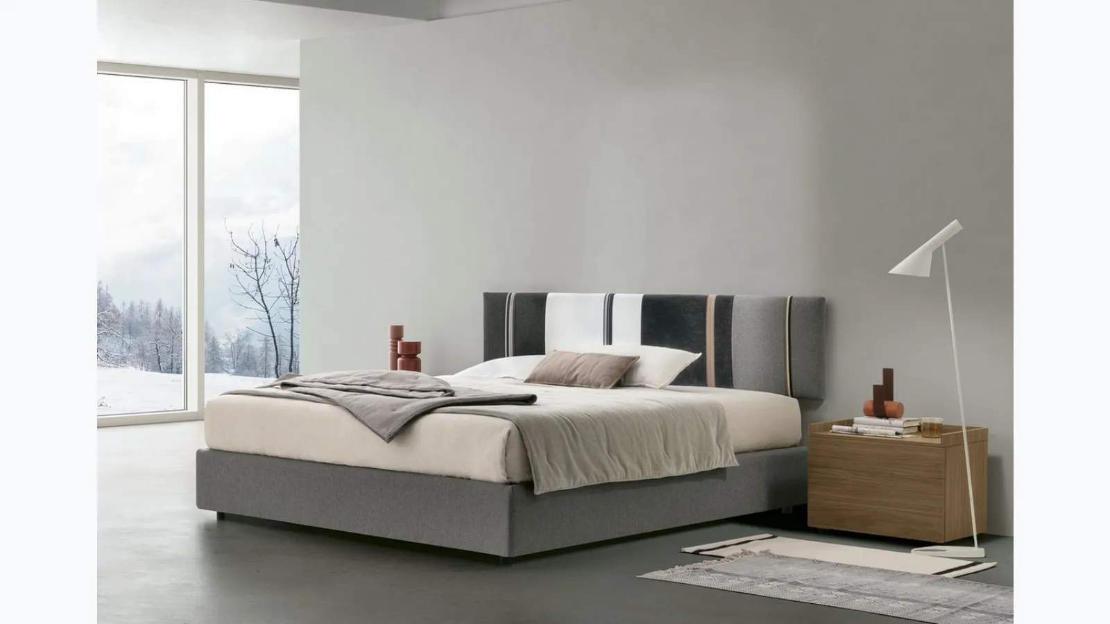 Diagonal bed with storage box and headboard panel by Tomasella.