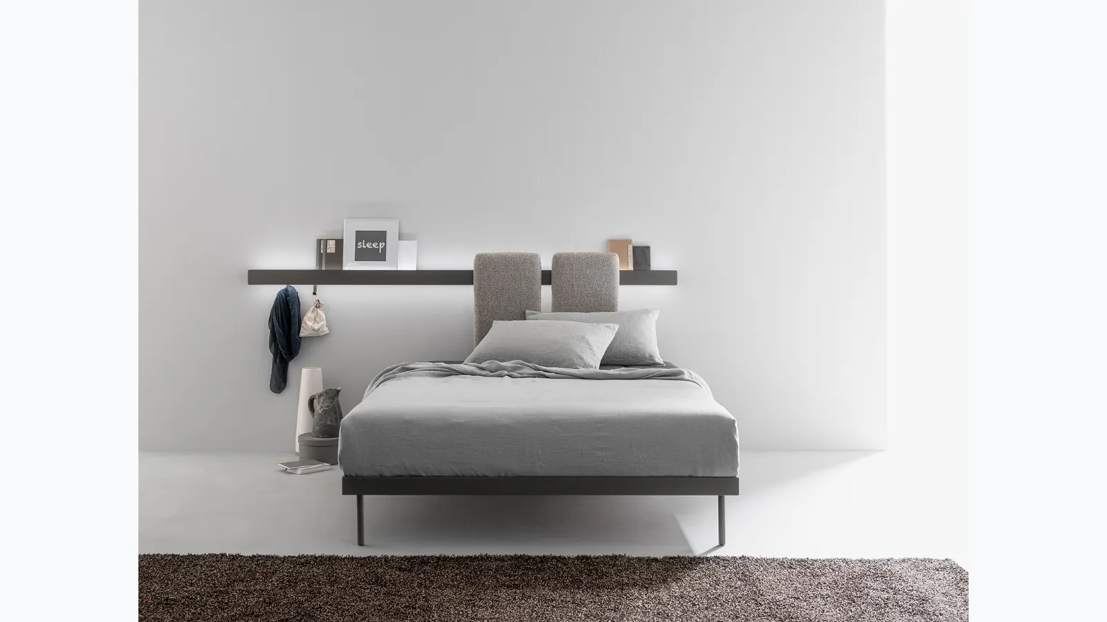Metal bed with sliding, padded and removable panels to be hooked onto the bar fixed to the Groove Run wall by Caccaro.