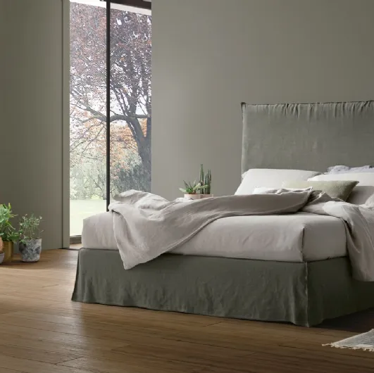 Bed with upholstered Hera headboard in fabric by Tomasella.