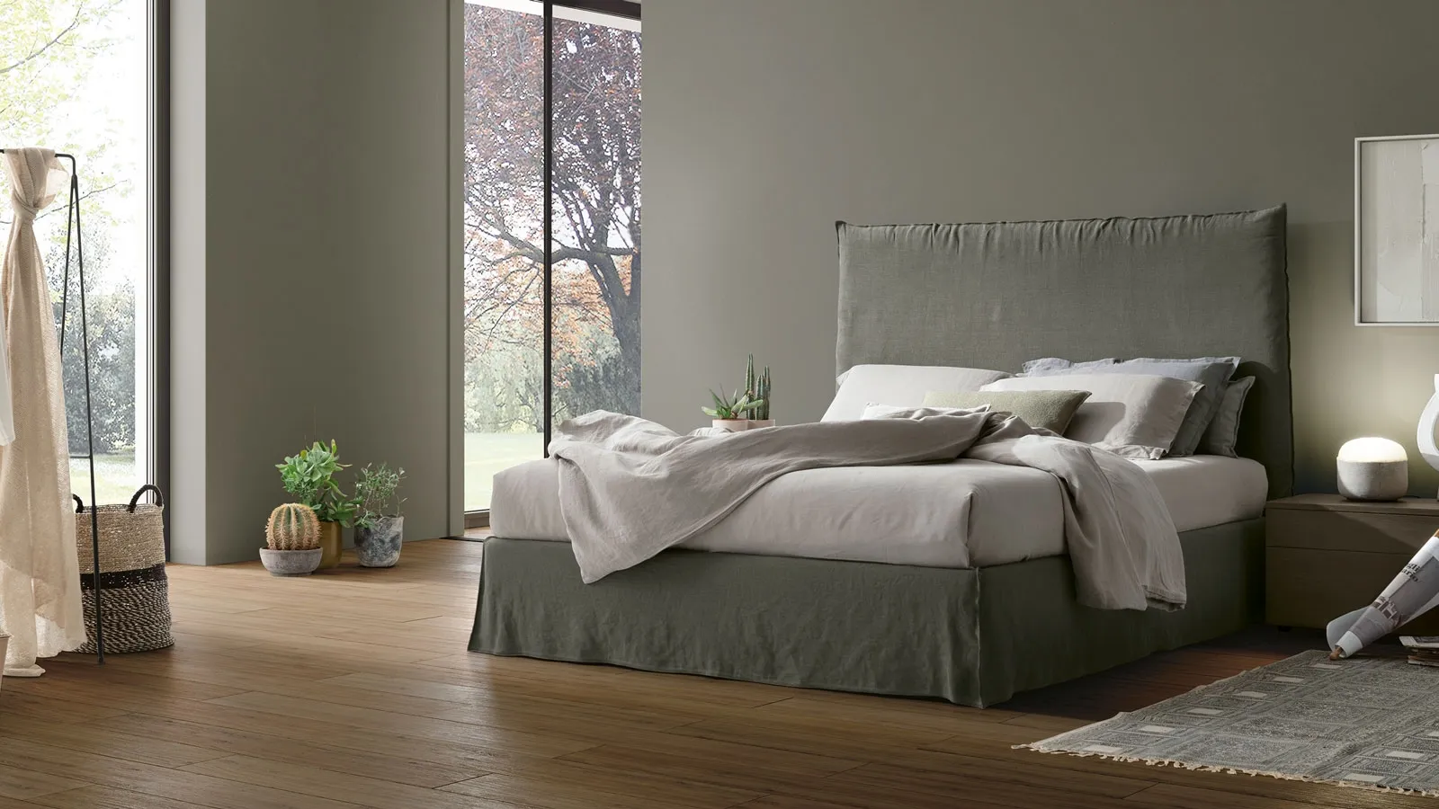 Bed with upholstered Hera headboard in fabric by Tomasella.