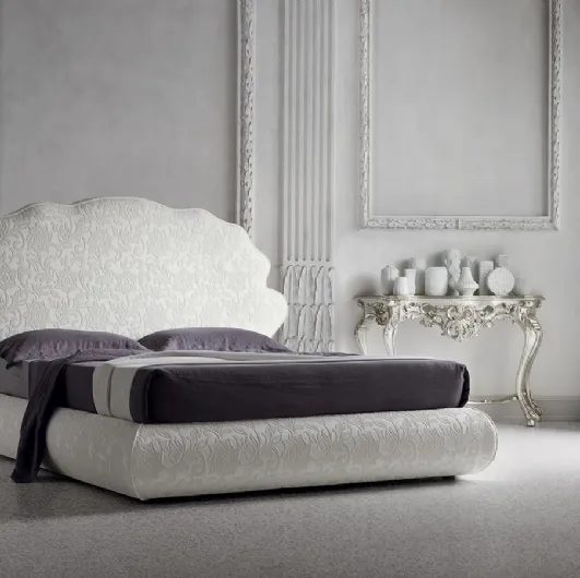 Tone-on-tone floral fabric bed with Jason headboard by Felis.
