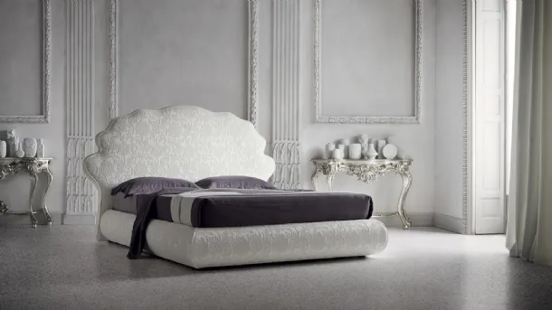 Tone-on-tone floral fabric bed with Jason headboard by Felis.