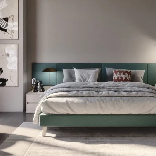 Fabric bed with Jolly headboard and padded panels in S75 fabric.