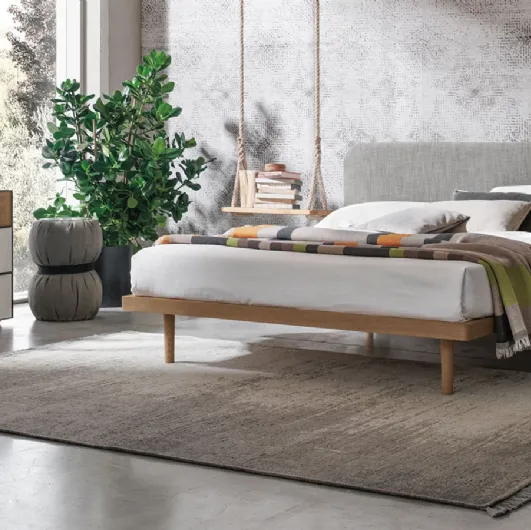 Wooden bed with Milly fabric headboard by Tomasella.