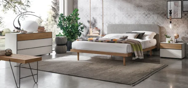 Wooden bed with Milly fabric headboard by Tomasella.