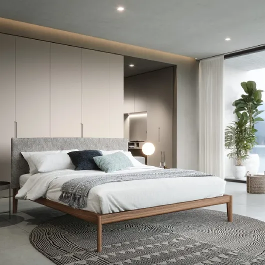 Walnut Neos bed with headboard upholstered in Novamobili fabric.