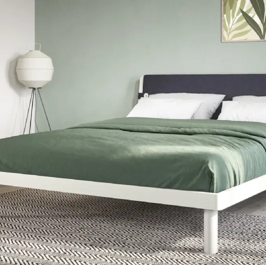 Double bed with headboard covered in Fifty3 Suez fabric.