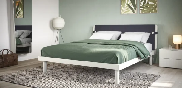 Double bed with headboard covered in Fifty3 Suez fabric.