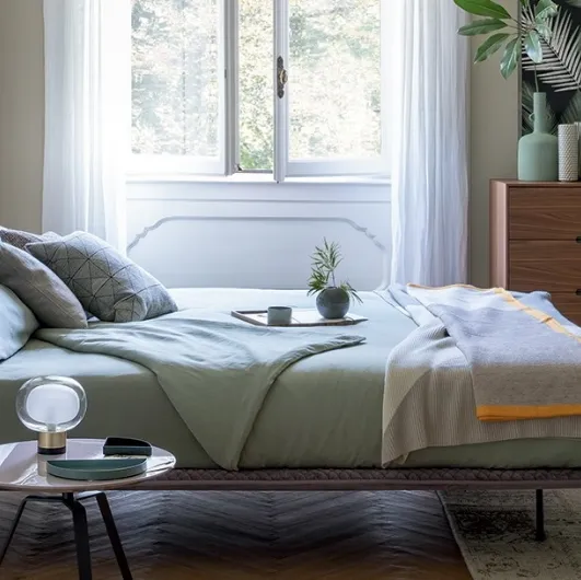 Bonaldo's Thin bed in quilted fabric with headboard.