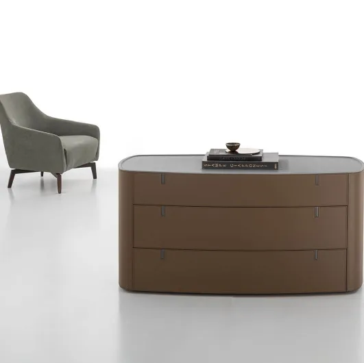 Round leather-covered dresser with top in Alivar's acrylic stone.