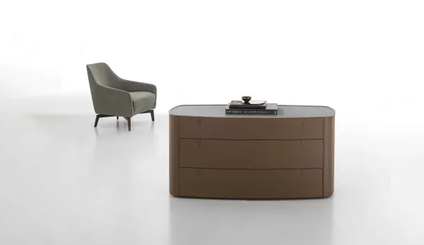 Round leather-covered dresser with top in Alivar's acrylic stone.