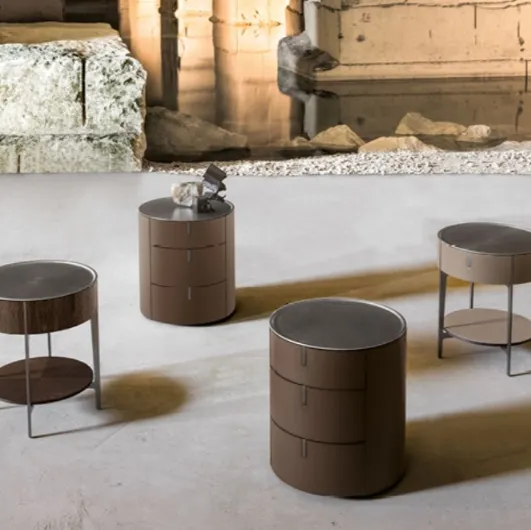 Round bedside table covered in leather with a steel top by Alivardi Alivar.