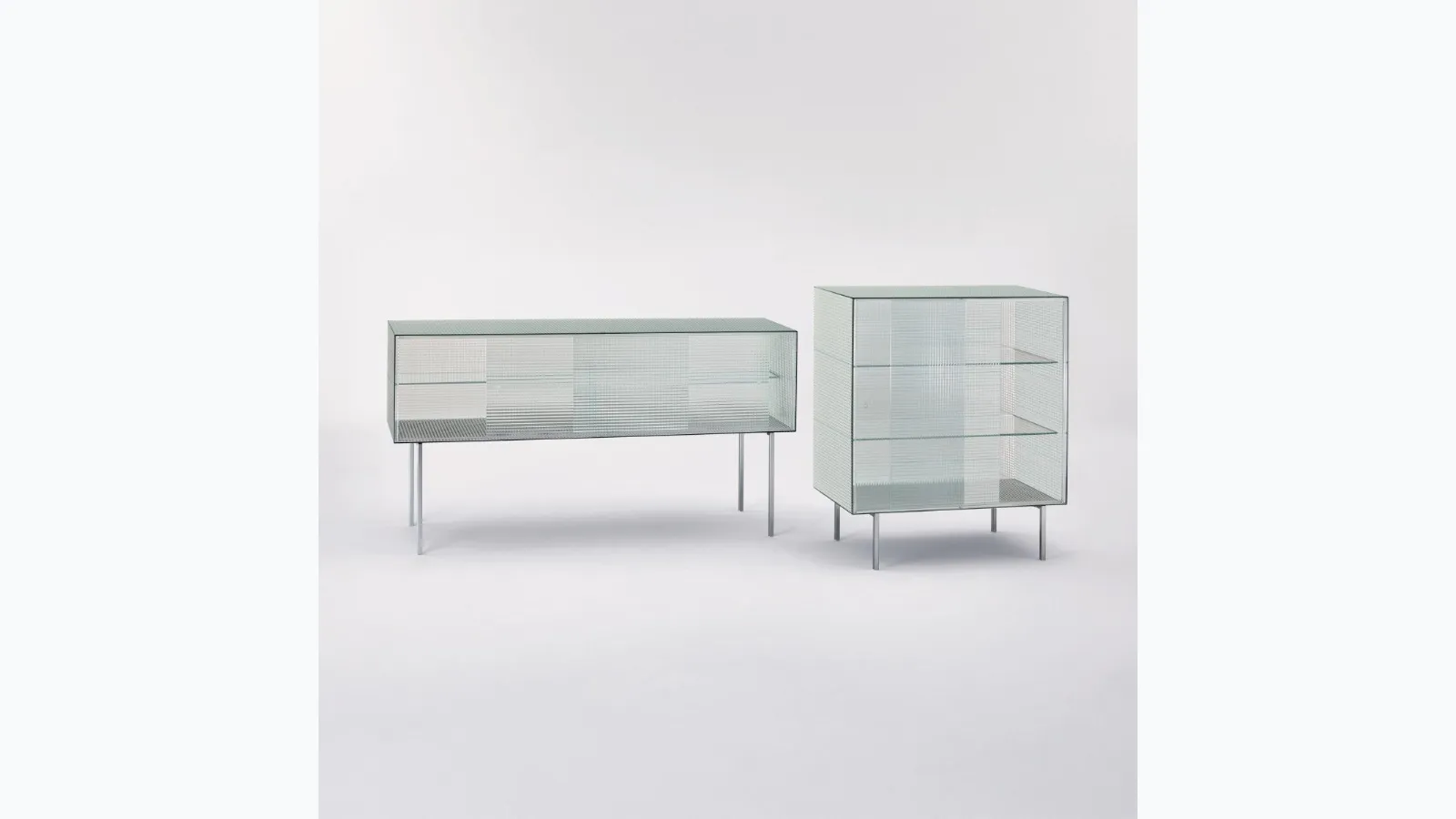 Madie Commodore with sliding doors in printed glass with square pattern and shiny chromed metal feet by Glas Italia.