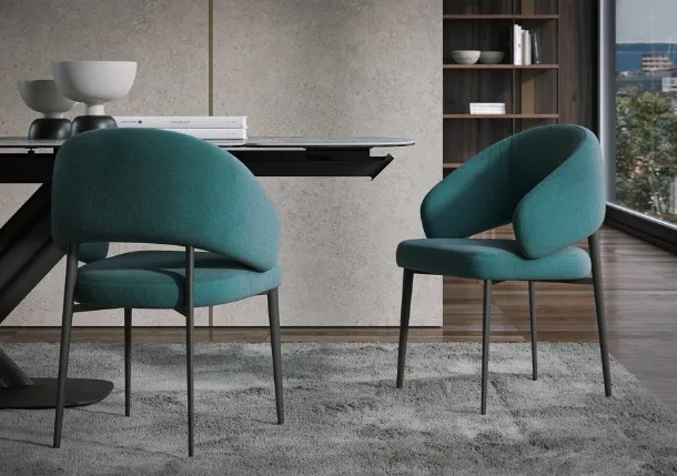Astra chair upholstered in fabric by Tonin Casa.