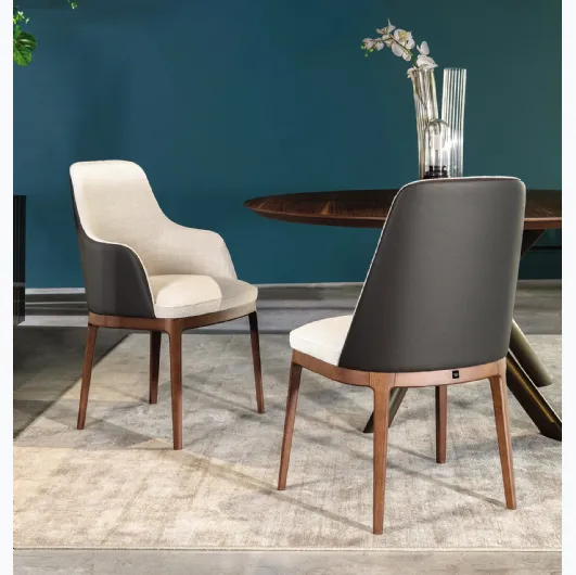 Chair with and without armrests Cleo in fabric with leather back by Tonin Casa.