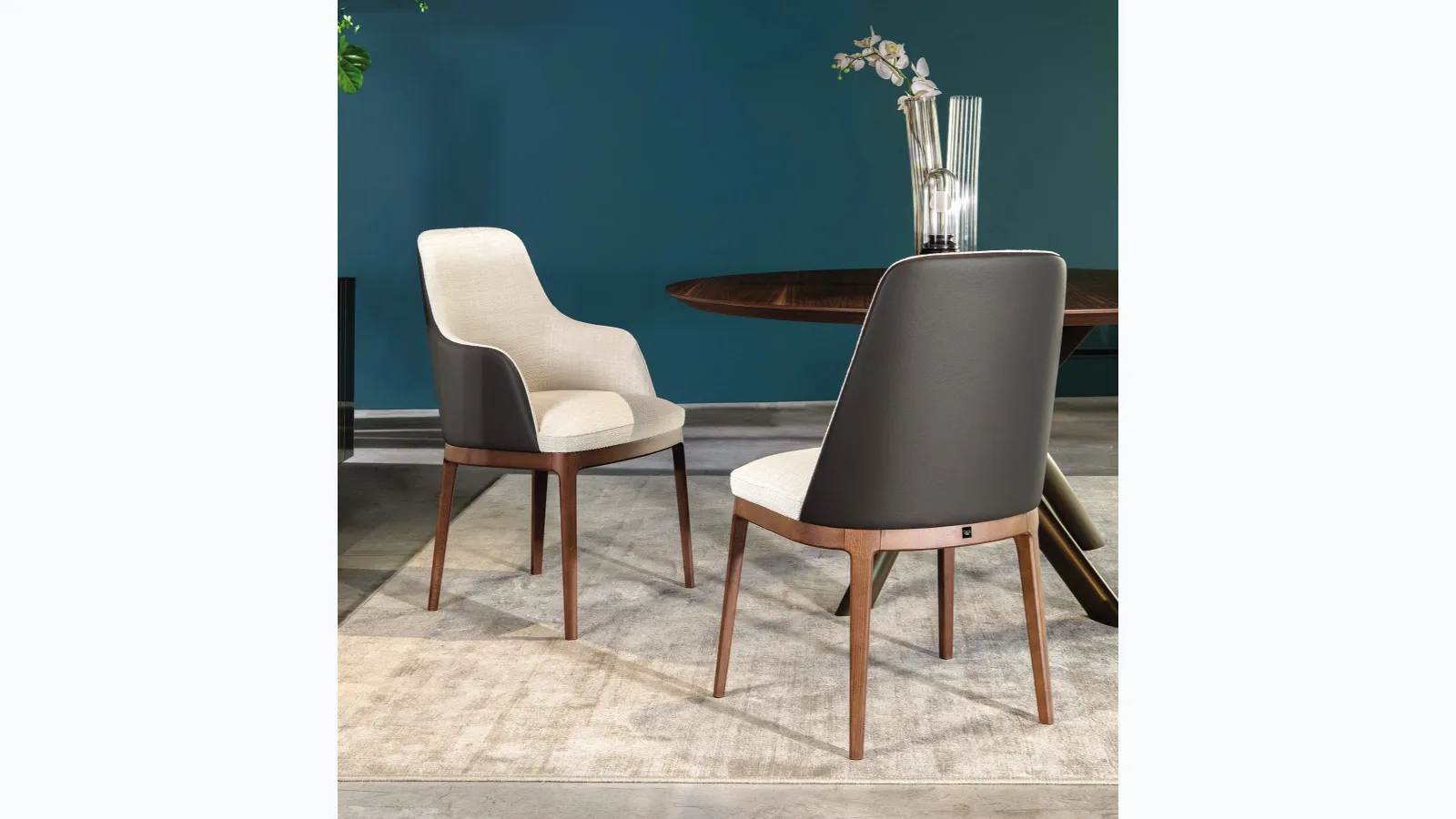 Chair with and without armrests Cleo in fabric with leather back by Tonin Casa.