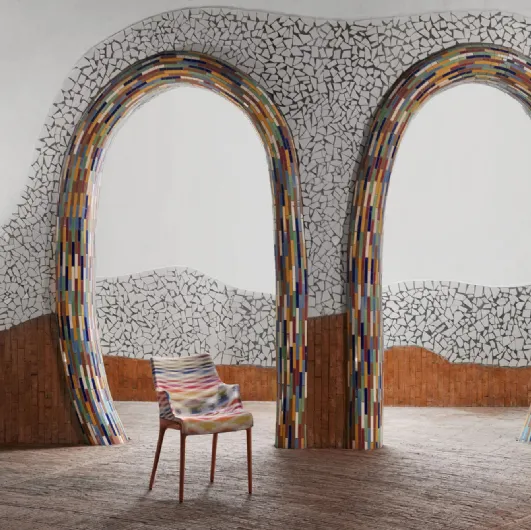 Elegance chair Nia by Kartell, made of plastic covered in fabric with armrests.