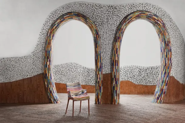Elegance chair Nia by Kartell, made of plastic covered in fabric with armrests.