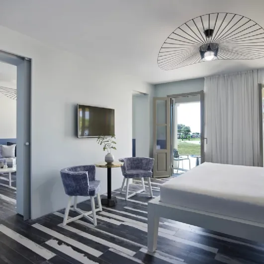 Gray padded chair by Gervasoni.