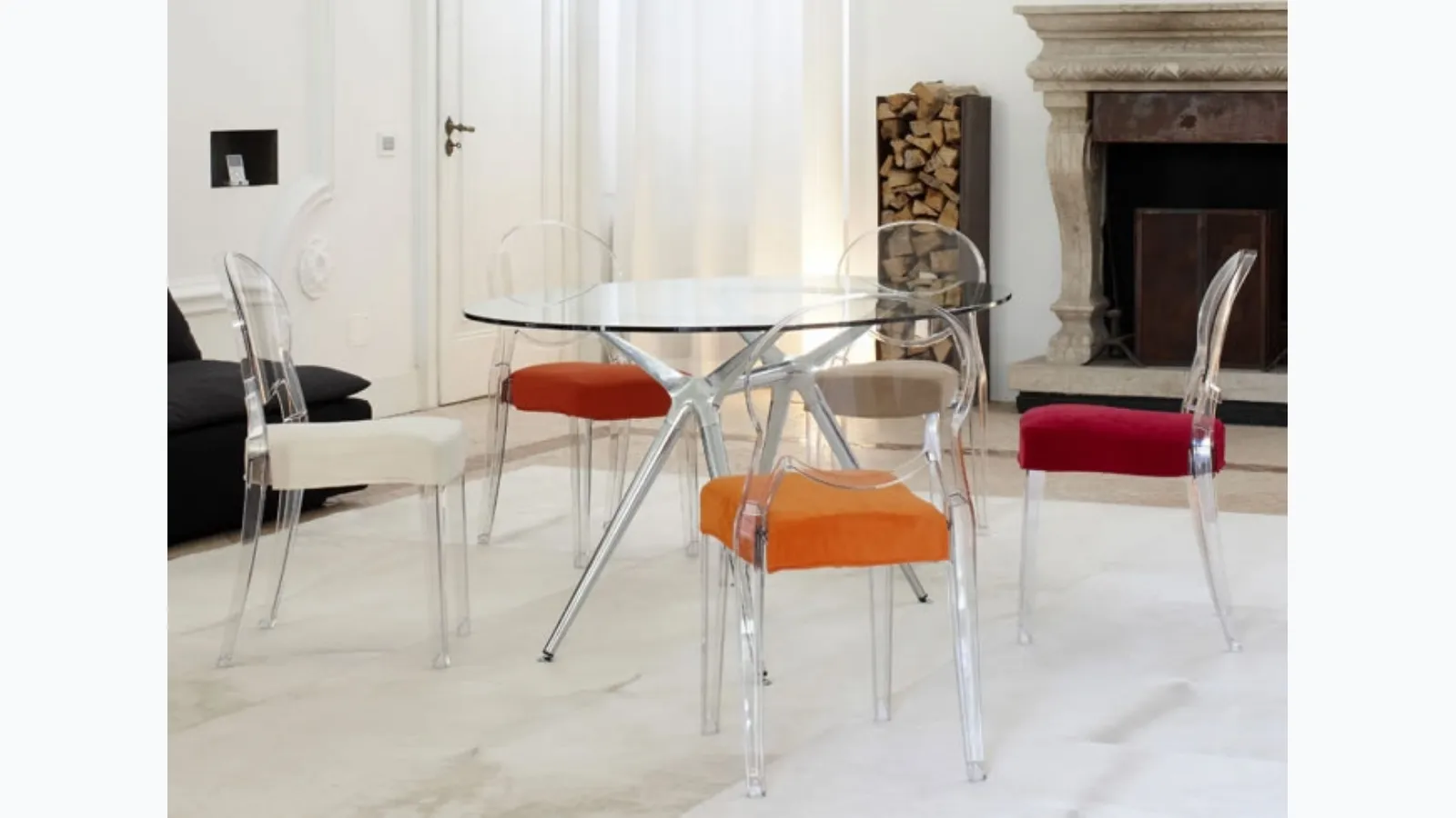 Stackable chair in transparent polycarbonate with seat upholstered in Igloo fabric by Scab Design.