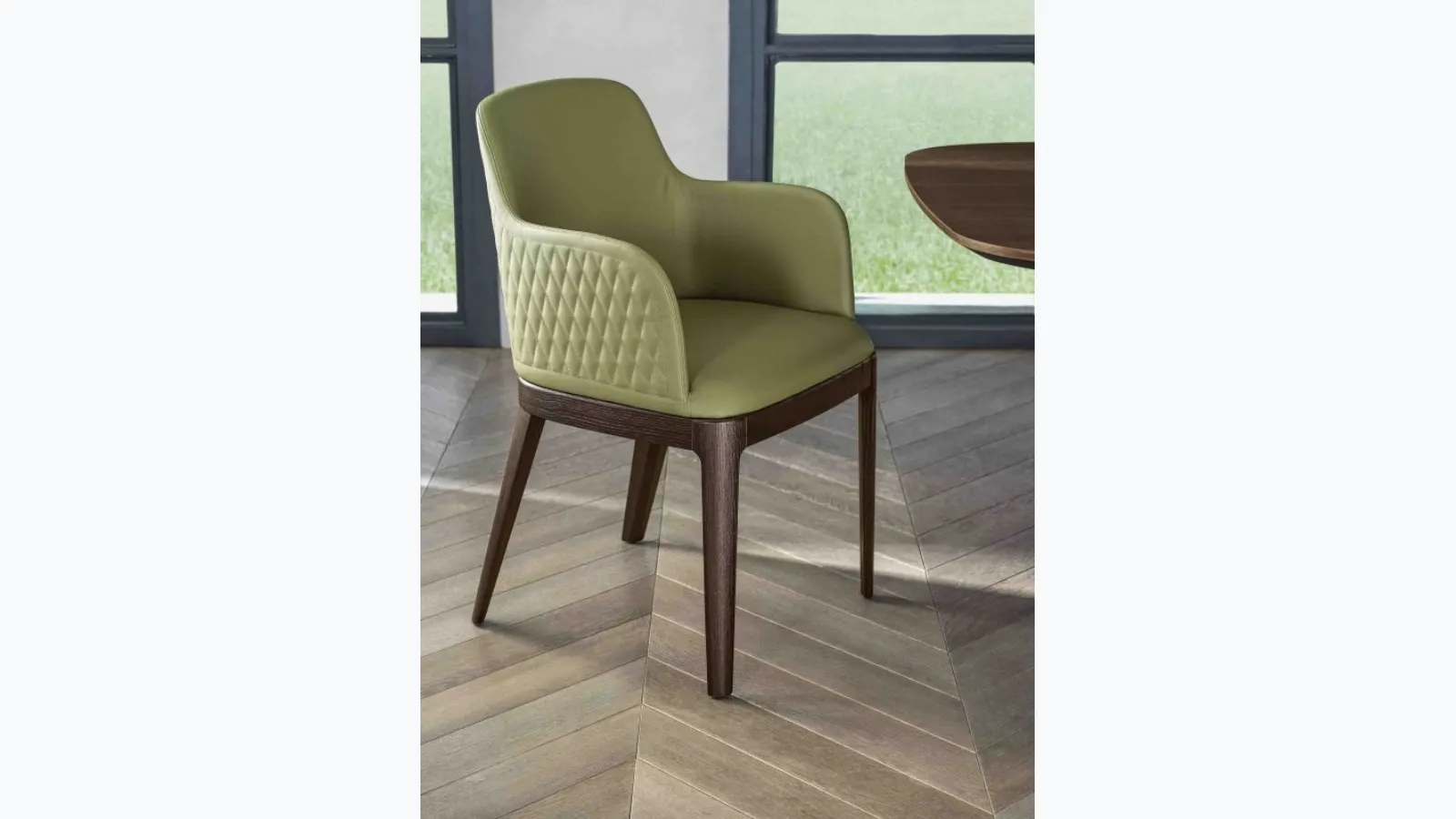 Margot armchair upholstered in quilted leather and solid wood base by Bontempi.