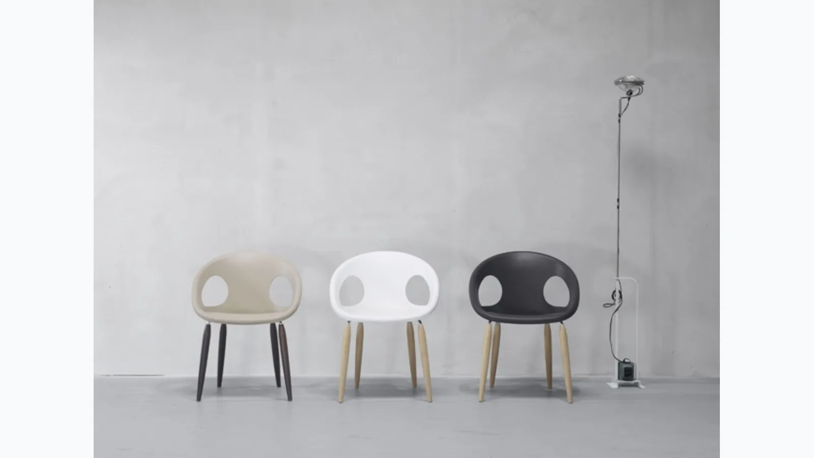 Natural Drop chair with technopolymer shell and solid wood legs in natural oak or wenge-stained beech by Scab Design.
