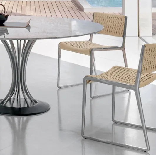 Chair with seat and backrest embellished by a sophisticated rope weave and Wing aluminum casting structure by Alivar.