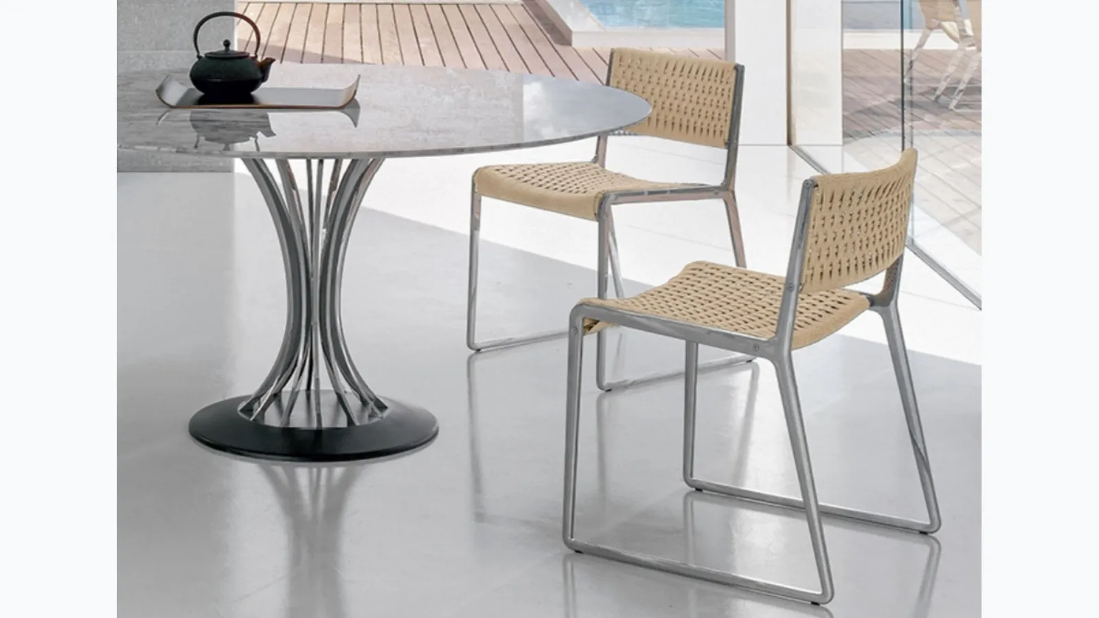 Chair with seat and backrest embellished by a sophisticated rope weave and Wing aluminum casting structure by Alivar.