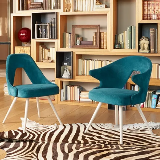 Chair with and without arms with wooden legs and upholstered fabric seat by Scab Design.
